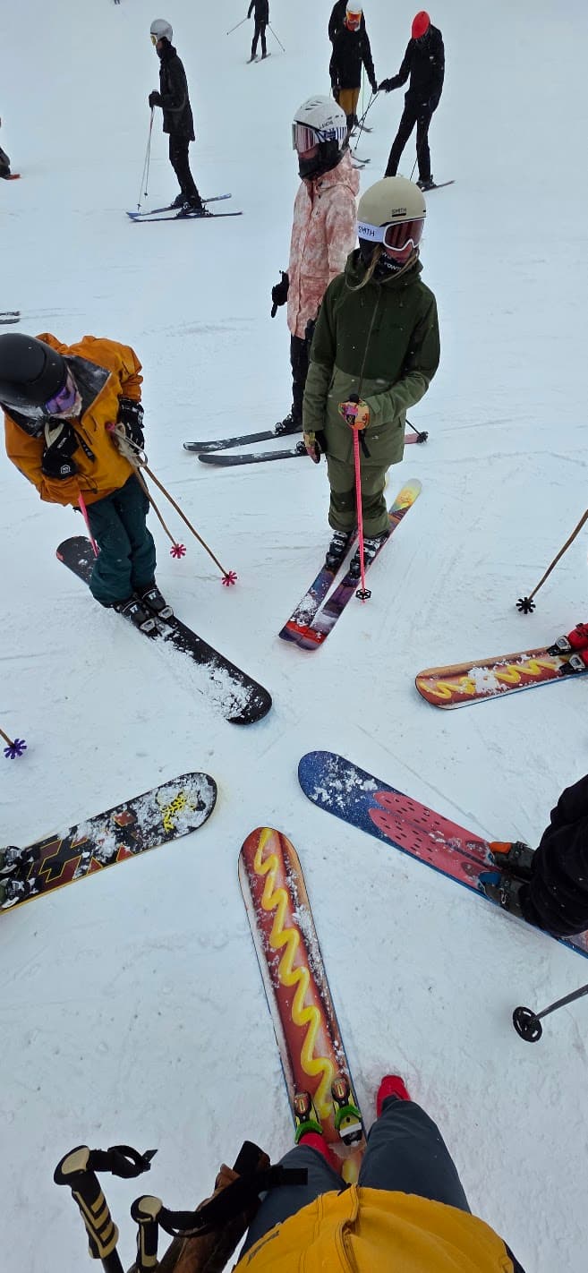 Monoski riders gathered in a demo circle on snow